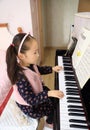 Little girl playing the piano at home Royalty Free Stock Photo