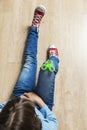 Little girl playing with green fidget spinner toy