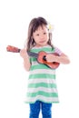 Little girl playing guitar toy over white background Royalty Free Stock Photo