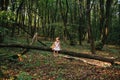 Little girl playing with her bear in the woods. girl sitting on Royalty Free Stock Photo