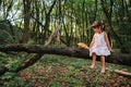 Little girl playing with her bear in the woods. girl sitting on Royalty Free Stock Photo