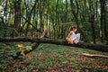 Little girl playing with her bear in the woods. girl sitting on Royalty Free Stock Photo