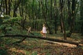 Little girl playing with her bear in the woods. girl sitting on Royalty Free Stock Photo