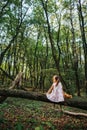 Little girl playing with her bear in the woods. girl sitting on Royalty Free Stock Photo