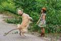 Little girl playing with her big dog outdoors in rural areas in summer Royalty Free Stock Photo