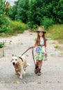 Little girl playing with her big dog outdoors in rural areas in summer Royalty Free Stock Photo