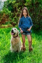 Little girl playing with her big dog outdoors in rural areas in summer Royalty Free Stock Photo