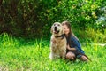 Little girl playing with her big dog outdoors in rural areas in summer Royalty Free Stock Photo