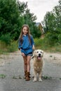 Little girl playing with her big dog outdoors in rural areas in summer Royalty Free Stock Photo