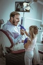 Little girl playing with her father at dentist office. Royalty Free Stock Photo