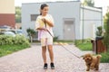 a little girl playing with her maltipoo dog a maltese-poodle breed Royalty Free Stock Photo