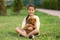 a little girl playing with her maltipoo dog a maltese-poodle breed Royalty Free Stock Photo