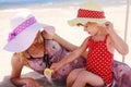 Little girl playing with her mother on the shore of the sea