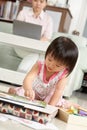 Little girl playing while her mother working Royalty Free Stock Photo