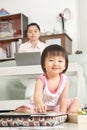 Little girl playing while her mother working Royalty Free Stock Photo