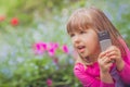 Little girl playing with her smartphone Royalty Free Stock Photo