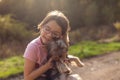 Little girl playing with her Yorkshire Terrier dog in the park Royalty Free Stock Photo