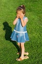 Little girl playing hide-and-seek