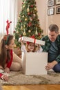 Little girl playing hide and seek with her parents on Christmas day Royalty Free Stock Photo