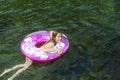 Little girl playing on an inflatable tube on a summer day Royalty Free Stock Photo