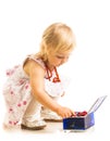 Little girl playing with jewelry box on a white background. Royalty Free Stock Photo