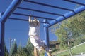 A little girl playing on the jungle gym, NM