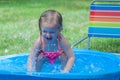 Little Girl Playing in a Kiddie Pool Royalty Free Stock Photo