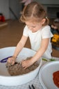 Little girl playing with kinetic sand and toys insect. Sensory development and experiences, themed activities with Royalty Free Stock Photo