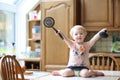 Little girl playing in the kitchen