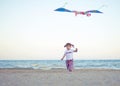 Little girl playing with a kite