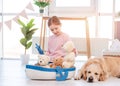 Little girl play with sea ship with golden retriever dog Royalty Free Stock Photo