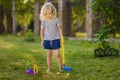 Little girl playing mini golf in spring park. Frustrated child, failure, missed Royalty Free Stock Photo