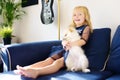 Little girl playing with 2-month old pomeranian spitz puppy. Cute fluffy small dog