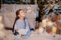 Little girl playing near the christmas tree