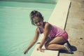 The little girl playing near the pool in the summer Royalty Free Stock Photo
