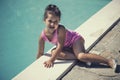 The little girl playing near the pool in the summer Royalty Free Stock Photo