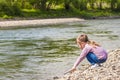 Little girl playing near the river Royalty Free Stock Photo