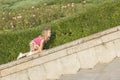 Little girl playing on parapet