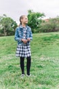 Little girl playing in the park in green background