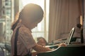 Little girl playing with piano and Music Tablet at home Royalty Free Stock Photo
