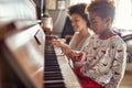 Girl is playing on piano x-mas music. Concept Christmas, New Year, holiday, family happiness, childhood Royalty Free Stock Photo