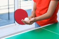 Little girl playing ping pong indoors, closeup Royalty Free Stock Photo