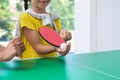 Little girl playing ping pong indoors, closeup Royalty Free Stock Photo