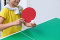 Little girl playing ping pong indoors, closeup Royalty Free Stock Photo