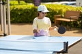 Little girl playing ping pong in park. Royalty Free Stock Photo