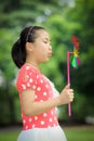 Little girl playing pinwheel Royalty Free Stock Photo