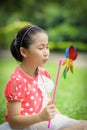 Little girl playing pinwheel Royalty Free Stock Photo