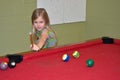 Little girl playing pool Royalty Free Stock Photo