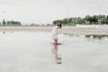 Little girl playing in a puddle, happy. stock photo