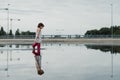 Little girl playing in a puddle, happy. stock photo